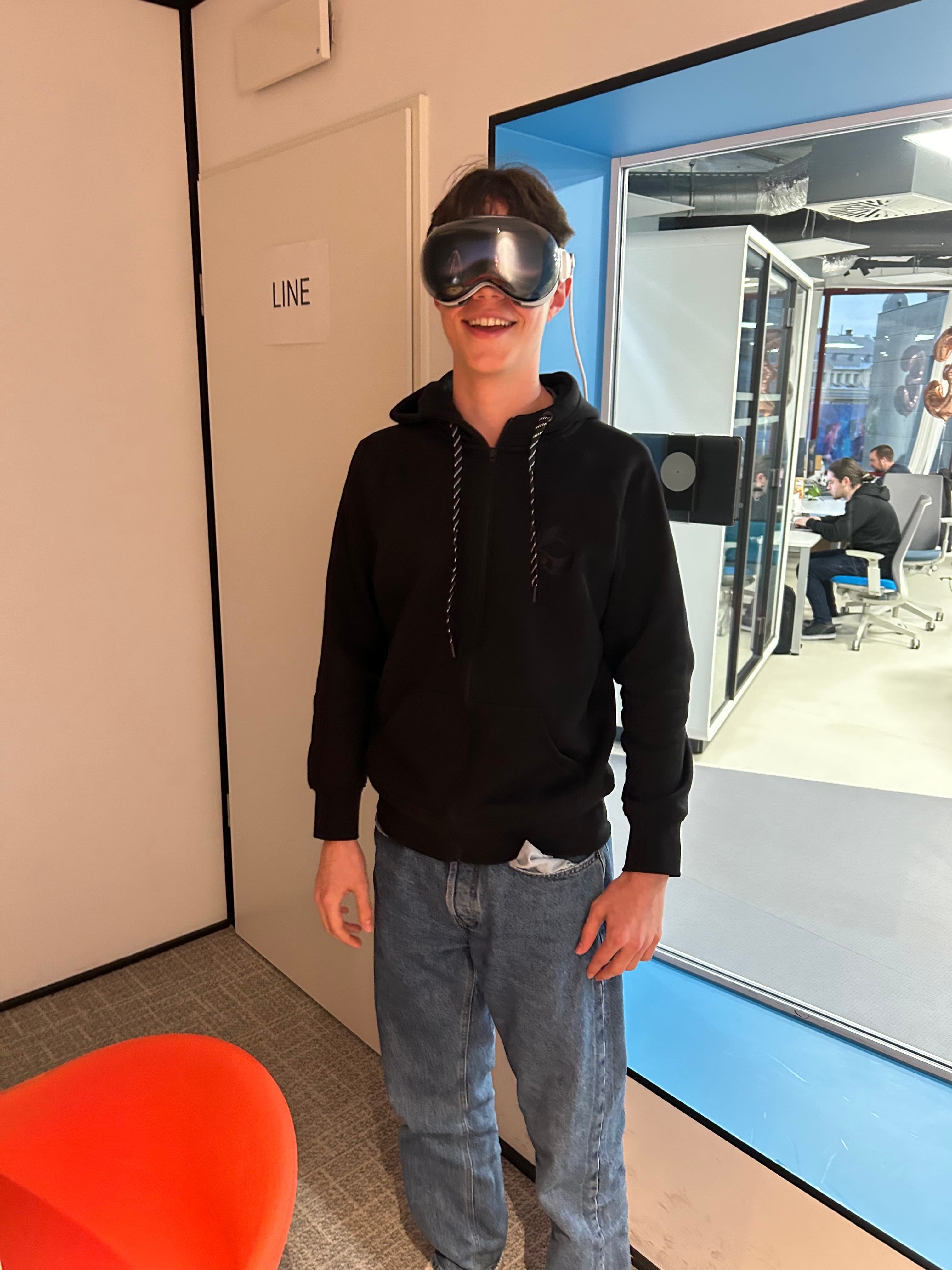 Julius wearing the Apple Vision Pro. In the background there is an office.